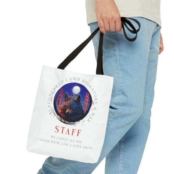 A person holding a bag with the word staff on it.