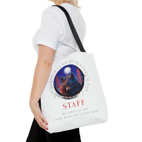 A woman is holding onto a bag with the word staff on it.