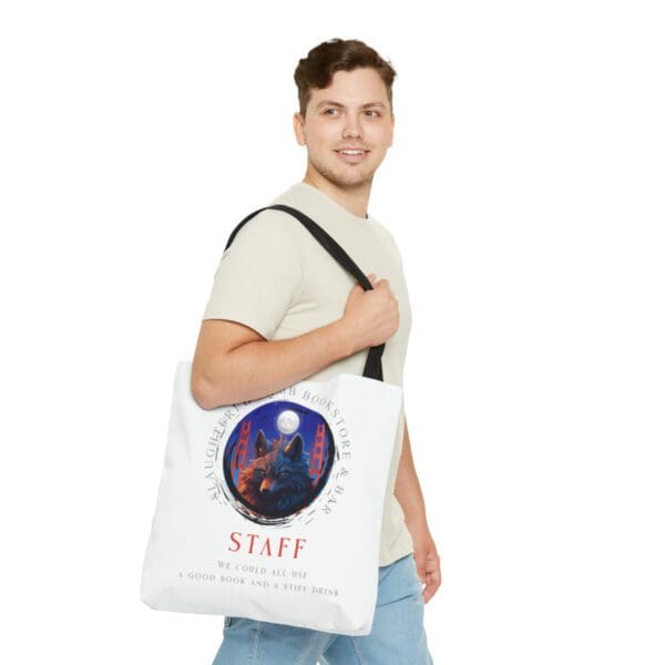 A man holding onto a bag with the word staff on it