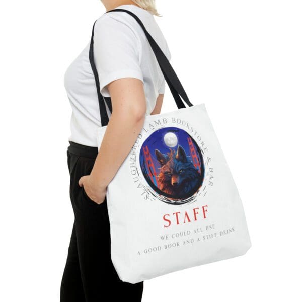 A woman is holding onto a bag with the word staff on it.