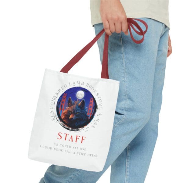 A person holding a bag with the word staff on it.