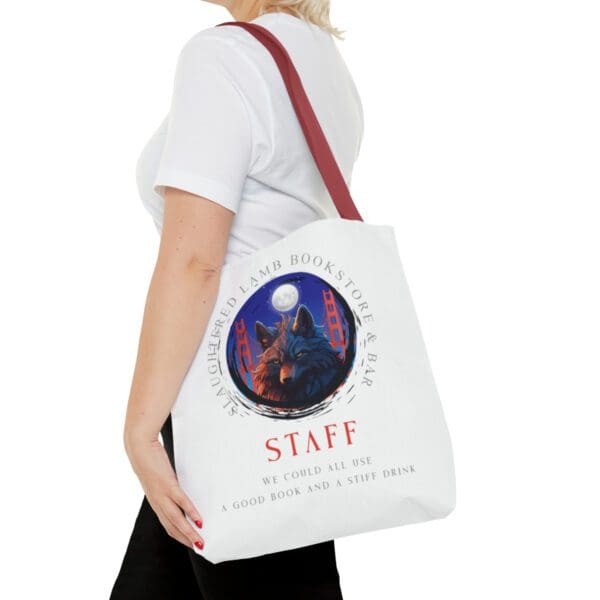 A woman holding onto a bag with the word staff on it