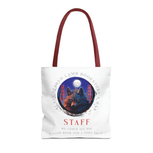 A red handled tote bag with an image of a wolf and the words staff.