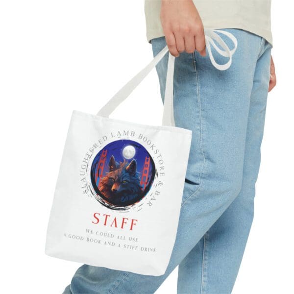 A person holding a bag with the word staff on it.