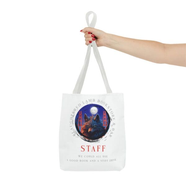 A hand holding a bag with the word staff written on it.