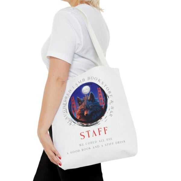 A woman is holding onto a bag with the word staff written on it.