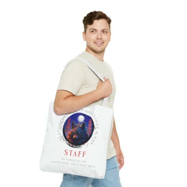 A man holding onto a bag with the word staff on it