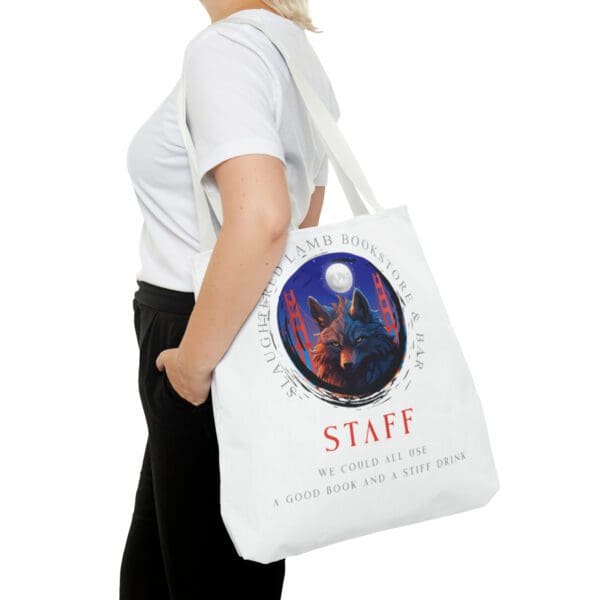 A woman is holding a bag with the word staff on it.