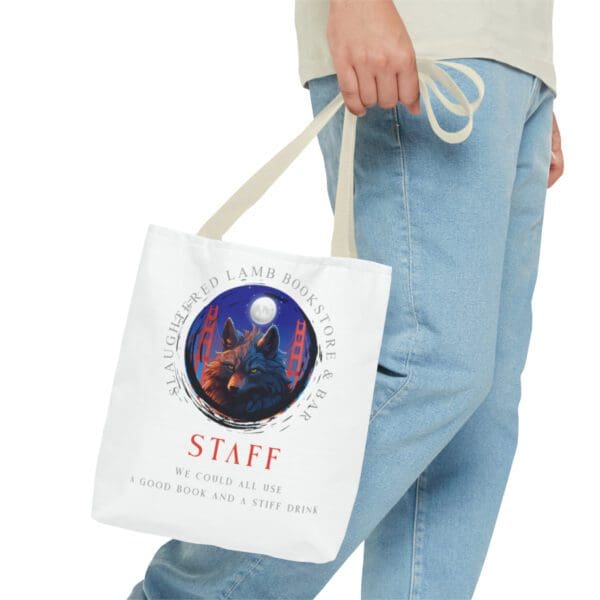 A person holding a bag with the word staff on it.