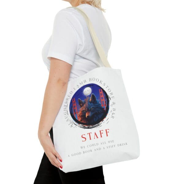 A woman holding onto a bag with the word staff written on it