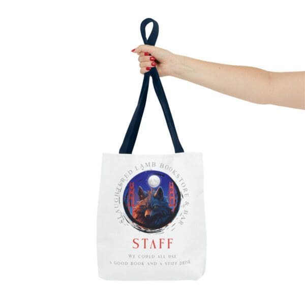 A hand holding a bag with the word staff on it.