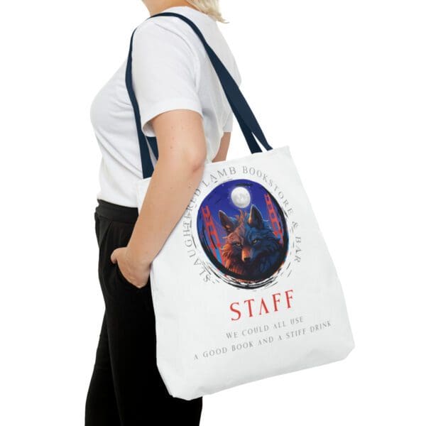 A woman is holding her bag with the words staff written on it.