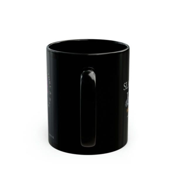 A black coffee mug with the words " you are here ".